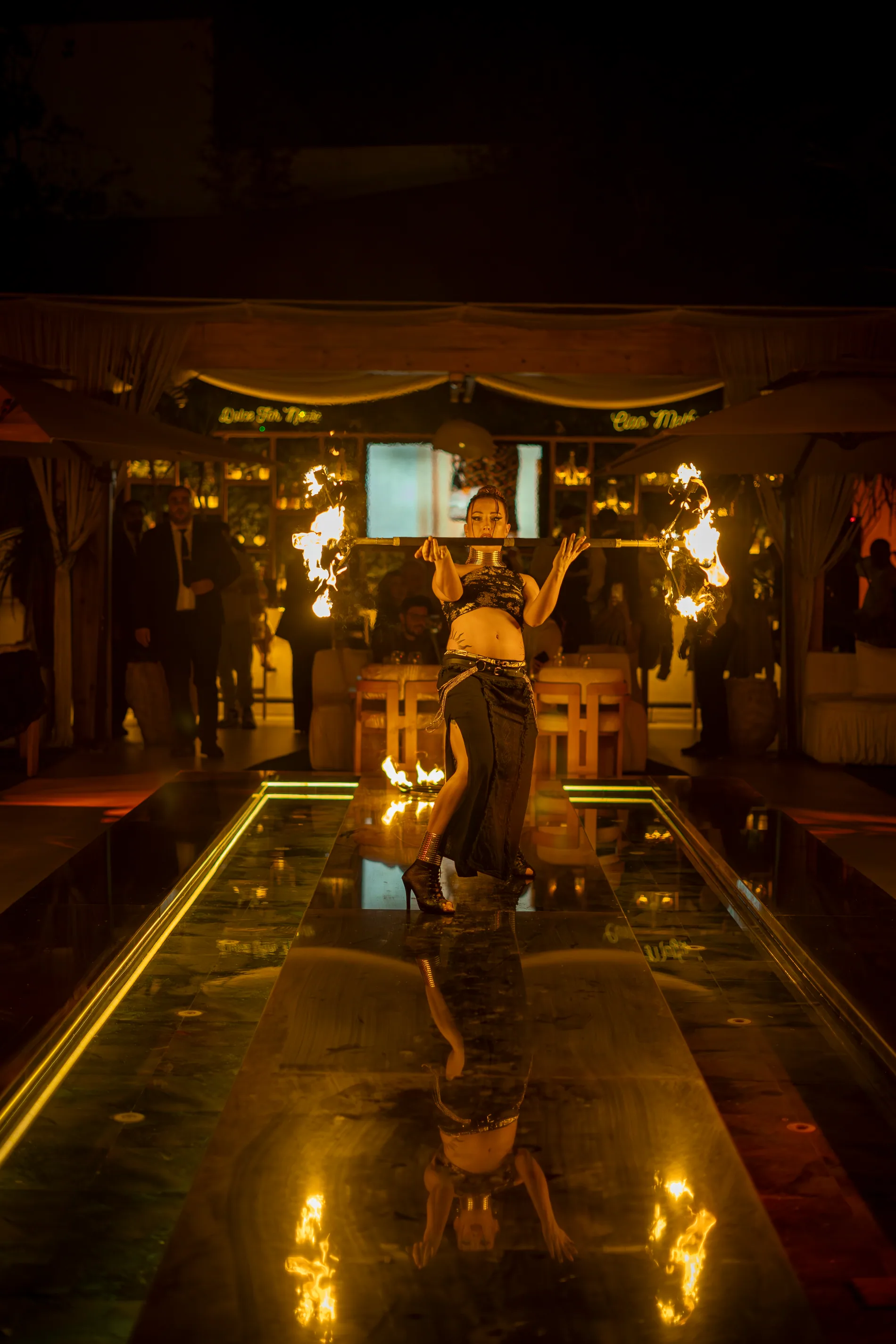 Sereia surrounded by fire during a performance